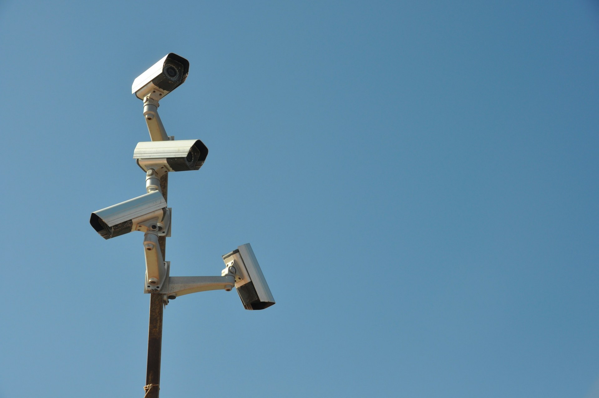 CCTV cameras illustrating continuous LLM brand monitoring and AI brand visibility analysis